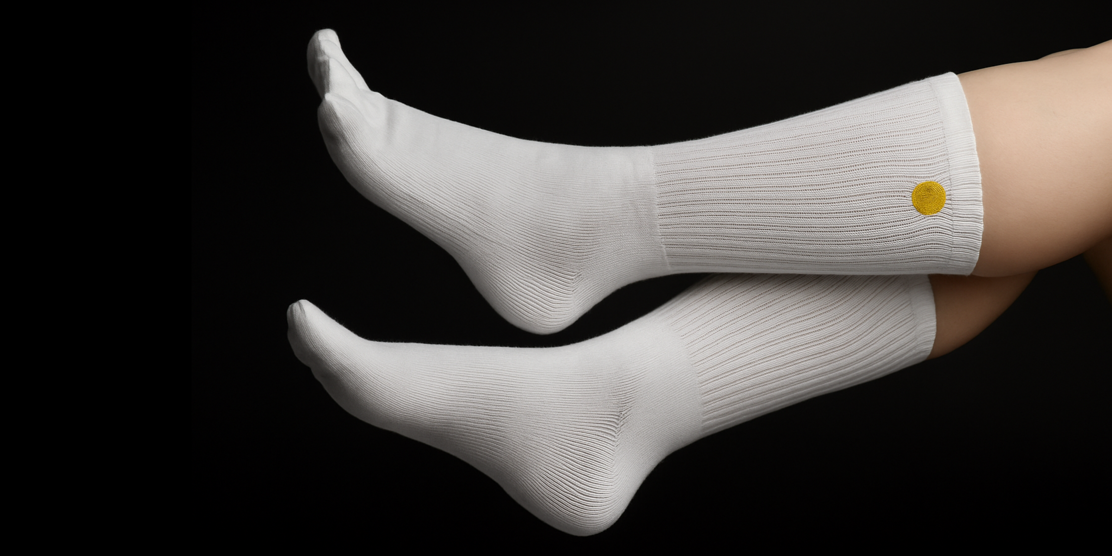 White Toe socks with a yellow logo on a black background