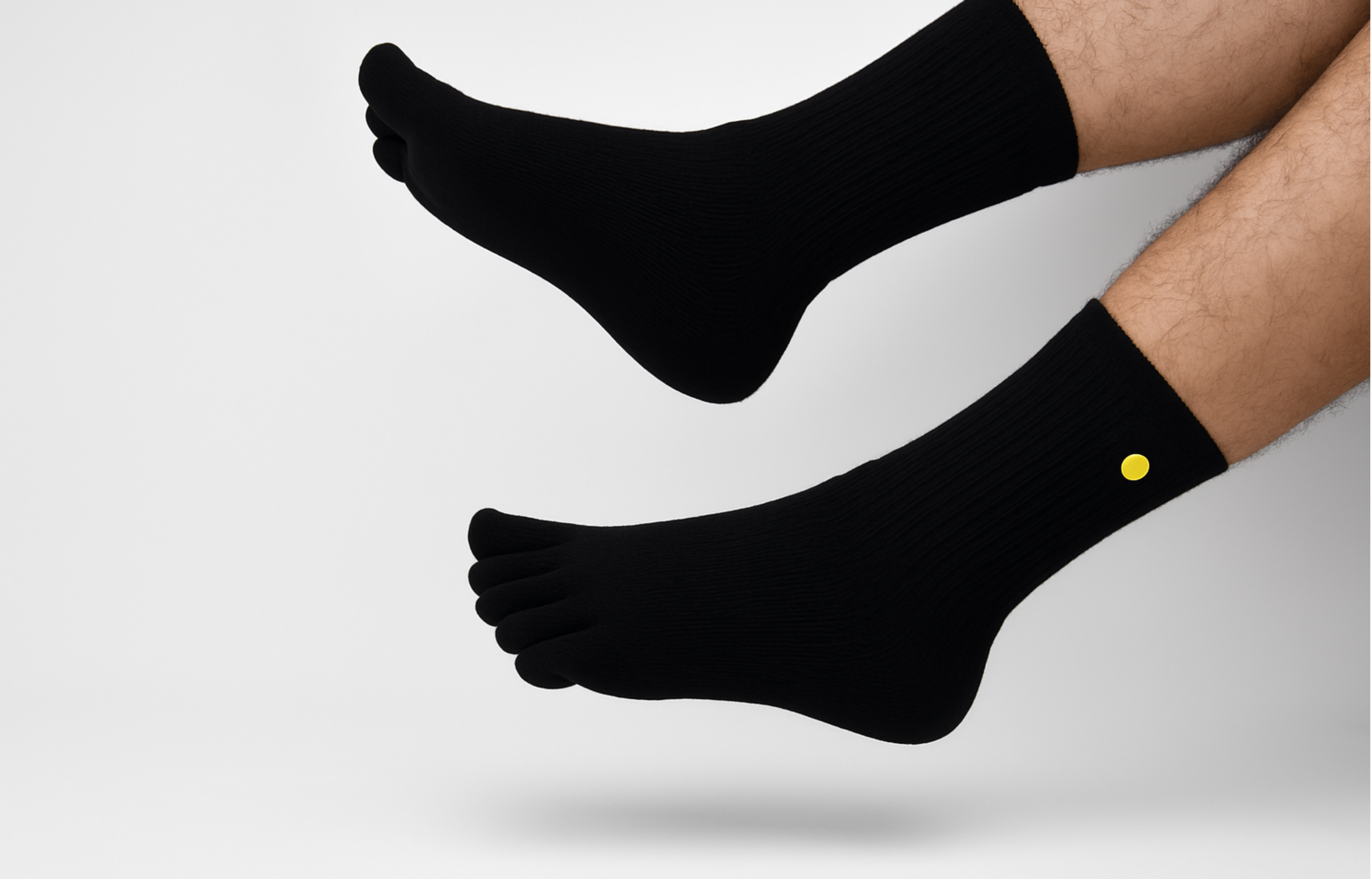 Black Toe socks with a yellow dot on a white background